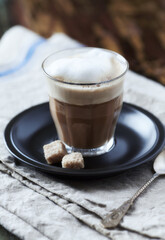 Coffee with milk on dark wooden background. Close up.	