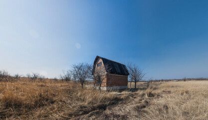 Old abandoned house in the field