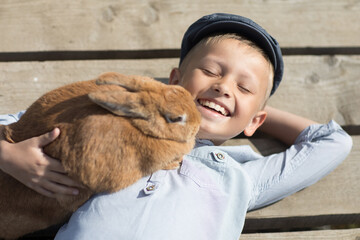 portrait of a boy with a rabbit