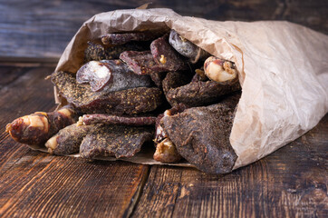 A paper craft bag filled with dried meat. Takeout products.