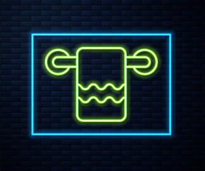 Glowing neon line Towel on a hanger icon isolated on brick wall background. Bathroom towel icon. Vector.