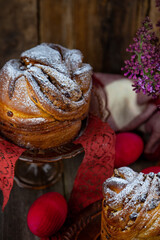 Easter cake kraffin. Kraffins with raisins, candied fruits and poppy seeds, sprinkled with powdered sugar. Close-up of homemade cake. Cruffin. Red colored eggs.