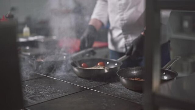 the process of cooking meat and fish with vegetables under the close supervision of the chef