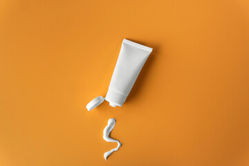 Top view blank label facial skincare white tube bottle with lid open product squeezed lotion or...