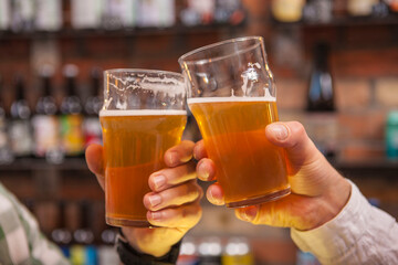 Unrecognizablemen clinking beer glasses