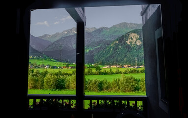 view through a window to a wonderful green mountain landscape