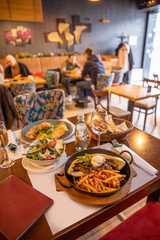 Kebabs served with milk cream and french fries in restaurant