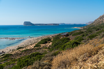 Fototapeta na wymiar Amazing Panoramic view of Balos Lagoon near Chania, with magical turquoise waters, lagoons, tropical beaches of pure white, pink sand and Gramvousa island on Crete, Cap tigani in the center. Greece