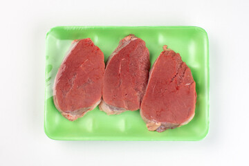 Beefsteak in green plastic container