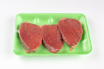 Beefsteak in green plastic container