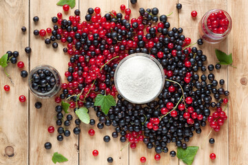 Fresh berries of black and red currants and sugar. Preparation of the berry for the preparation of jam. Composition in a rustic style, top view