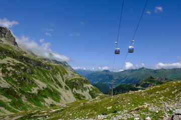 cable car with two gondolas next to each other in the mountains