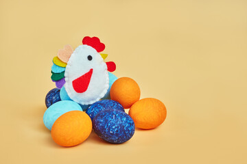 toy chicken on easter eggs. yellow background