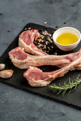 Raw lamb ribs on black background