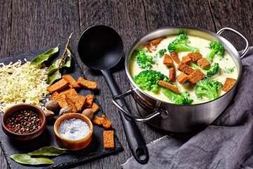 cream soup with broccoli and croutons in a pot