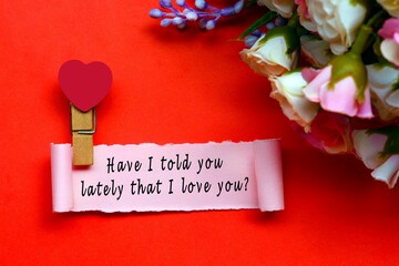 Have I told you lately that I love you label on torn paper on red background