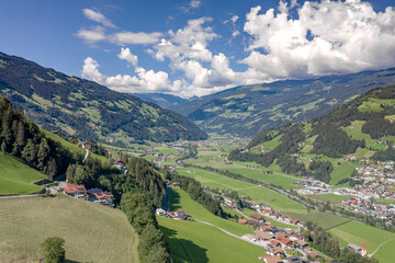 Naklejka premium Aerial drone shot of Zillertal valley with clouds in Tyrol Austria summer