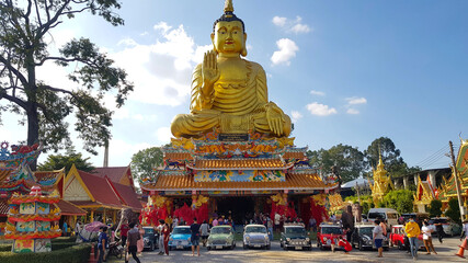 Nakhon Nayok, Thailand -December 5, 2020: Austin Mini cooper and classic car parked in Thai temple with golden buddha statue and blue sky background. Transportation, Religion and Group of old vehicle.