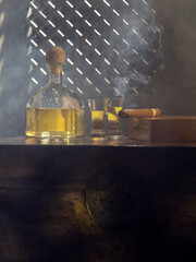 Close up view of bottle of tequila anejo and cigar on color background