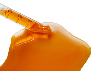 Isolate pipettes with orange oil from sea buckthorn berries on a white background. Fill the pipette...