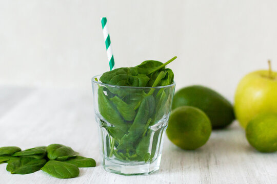 Healthy Green Smoothie With Spinach, Avocado, Lime, Pinapple   On Wooden Table 