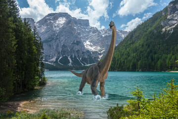 Brachiosaurus walks alone into cold lake before dinosaurs extinction. Snow on the mountains in the background. - obrazy, fototapety, plakaty