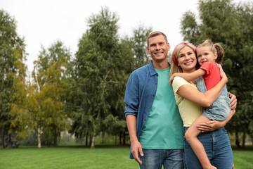 Obraz premium Happy family spending time together in park on sunny summer day