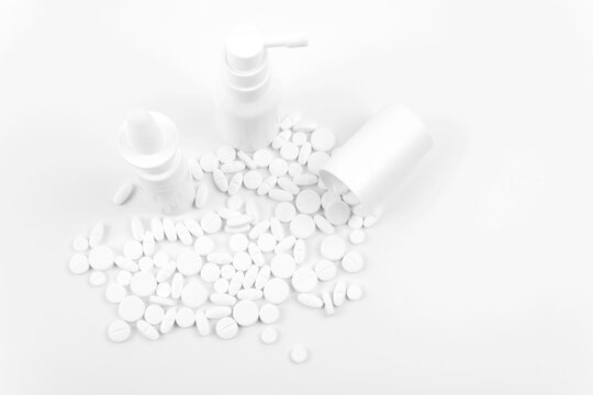 Different white pills on a white background.
