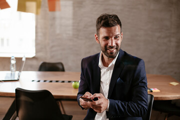 Businessman in conference room use sticky notes on glass wall. Handsome businessman making a business plan.