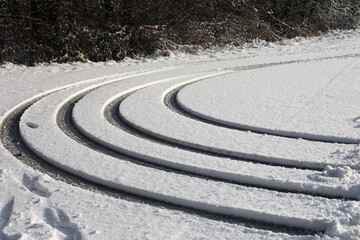 Concentric tire tracks of a car in the snow