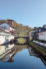 Fototapeta na wymiar Saint Jean Pied de Port with the Old bridge over the river Nive and the houses along the river in the Basque Country, Spain