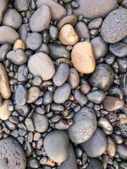 Different colors of pebbles on Reunion island east sea shore