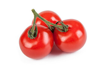 Fresh cherry tomatoes with a sprig isolated on a white background. View from another angle in the...