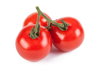 Fresh cherry tomatoes with a sprig isolated on a white background. View from another angle in the...