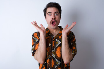 Surprised terrified Young caucasian man wearing generic pattern  Gestures with uncertainty, stares...