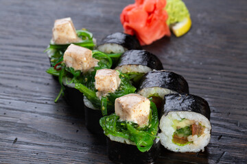 traditional vegetarian Japanese sushi with avocado and soft cheese, cucumber and algae. Japanese kitchen. Japanese restaurant.