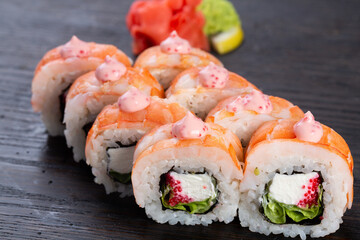 traditional Japanese sushi with salmon, avocado and soft cheese, garnished with red caviar. Japanese kitchen. Japanese restaurant.