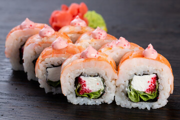 traditional Japanese sushi with salmon, avocado and soft cheese, garnished with red caviar. Japanese kitchen. Japanese restaurant.