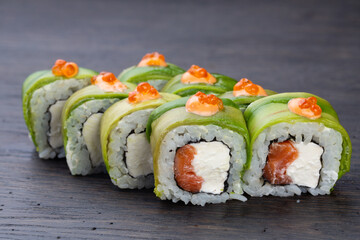 traditional Japanese sushi with salmon, avocado and soft cheese, garnished with red caviar. Japanese kitchen. Japanese restaurant.