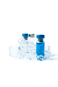 Several different Bottle of Covid-19, Coronavirus or SARS-CoV-2 vaccine on a Sterile Transparent Vial on an ice. Concept: keeping vaccine cold.