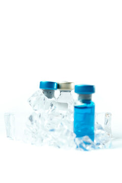 Several different Bottle of Covid-19, Coronavirus or SARS-CoV-2 vaccine on a Sterile Transparent Vial on an ice. Concept: keeping vaccine cold.