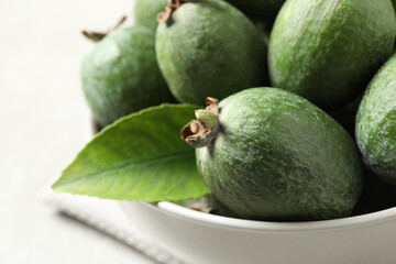 Delicious fresh feijoas in bowl on table, closeup