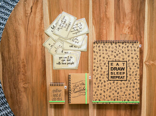 Lots of notebooks on wooden table and top view
