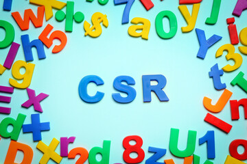 Abbreviation CSR made of plastic letters on light blue background, flat lay. Corporate social responsibility