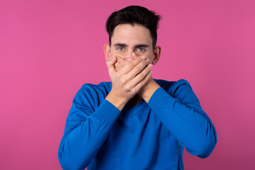 A young guy in a blue sweater. Don't speak evil. Do not listen to evil. Do not speak evil. Pink...