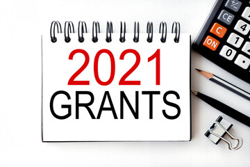 Business concept of starting 2021. 2021 grants, text on white notepad paper on white background...