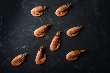 a bunch of boiled shrimp on a black background