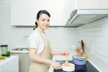 Beautiful woman cooking something in the kitchen