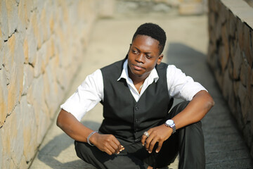 Fototapeta na wymiar Portrait of young handsome afro black man posing outdoor.