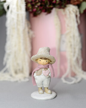 Statuette of a little Valentine. Toy gentelmen. Valentines day concept. Cute enamored boy fiigurine on grey background.